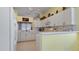 Bright kitchen with white cabinets, breakfast bar, and view of backyard at 1009 Harbor Town Dr, Venice, FL 34292