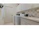 Convenient laundry room with washer, dryer, and storage at 1009 Harbor Town Dr, Venice, FL 34292