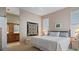 Spacious main bedroom with large bed and ensuite bath at 1009 Harbor Town Dr, Venice, FL 34292