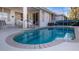 Inviting kidney-shaped pool with patio and surrounding landscaping at 1009 Harbor Town Dr, Venice, FL 34292