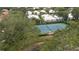 Community tennis court surrounded by lush trees at 1009 Harbor Town Dr, Venice, FL 34292