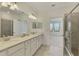 Double vanity bathroom with walk-in shower at 10217 Staggerbush Dr # 202, Venice, FL 34293