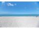 Scenic beach view with people relaxing under umbrellas at 10217 Staggerbush Dr # 202, Venice, FL 34293