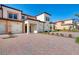 Townhome with two-car garage; brick paver driveway and landscaping at 10217 Staggerbush Dr # 202, Venice, FL 34293