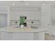 Modern kitchen with white cabinets and a large island at 10217 Staggerbush Dr # 202, Venice, FL 34293