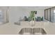 Kitchen island with double sink and breakfast bar at 10217 Staggerbush Dr # 202, Venice, FL 34293