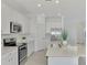 Modern kitchen with stainless steel appliances and an island at 10217 Staggerbush Dr # 202, Venice, FL 34293