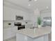 Modern kitchen with white cabinets, stainless steel appliances, and an island at 10217 Staggerbush Dr # 202, Venice, FL 34293