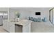 Open concept kitchen and living area with tile floors at 10217 Staggerbush Dr # 202, Venice, FL 34293