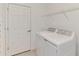 Convenient laundry room with washer, dryer, and shelving at 10217 Staggerbush Dr # 202, Venice, FL 34293