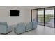 Spacious living room featuring a lake view and sliding glass doors at 10217 Staggerbush Dr # 202, Venice, FL 34293