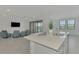 Open living room and kitchen with water view at 10217 Staggerbush Dr # 202, Venice, FL 34293