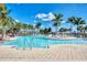 Relaxing pool area with palm trees and lounge chairs at 10217 Staggerbush Dr # 202, Venice, FL 34293