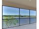Scenic screened balcony showcasing a tranquil lake view at 10217 Staggerbush Dr # 202, Venice, FL 34293