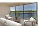 Peaceful screened balcony with lake view and comfortable seating at 10217 Staggerbush Dr # 202, Venice, FL 34293