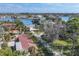 Aerial perspective of waterfront homes nestled amongst tropical foliage at 107 Louella Ln, Nokomis, FL 34275