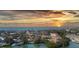 Stunning sunset over waterfront community with calm waters and vibrant sky at 107 Louella Ln, Nokomis, FL 34275