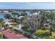 Aerial view of waterfront property with lush landscaping and mature trees at 107 Louella Ln, Nokomis, FL 34275