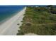 Aerial view of beach, shoreline, and beachfront homes at 107 Louella Ln, Nokomis, FL 34275