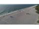 Aerial view of beach with people enjoying the sand at 107 Louella Ln, Nokomis, FL 34275