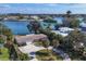 Aerial view of waterfront home with circular driveway, offering peaceful water views at 107 Louella Ln, Nokomis, FL 34275