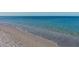 Soft white sand and gentle ocean waves at 107 Louella Ln, Nokomis, FL 34275