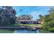 Single-story waterfront home with private dock and expansive lawn at 107 Louella Ln, Nokomis, FL 34275