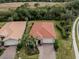 Single-story house with tile roof and brick driveway, aerial view at 11601 Parrotfish St, Venice, FL 34292