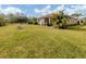 Large backyard with grassy area, screened patio, and grill at 11601 Parrotfish St, Venice, FL 34292