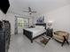 Main bedroom with king-size bed, large dresser and sitting area at 11601 Parrotfish St, Venice, FL 34292