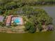 Aerial view of community pool with lounge chairs and a clubhouse at 11601 Parrotfish St, Venice, FL 34292