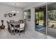 Dining room with table and chairs, access to screened patio and backyard at 11601 Parrotfish St, Venice, FL 34292