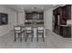 Modern kitchen with granite island, stainless steel appliances, and dark wood cabinets at 11601 Parrotfish St, Venice, FL 34292