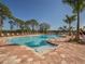 Community pool with lounge chairs and lake view at 11601 Parrotfish St, Venice, FL 34292