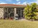 Screened patio with pavers and grill, adjacent to grassy yard at 11601 Parrotfish St, Venice, FL 34292