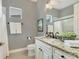 Stylish bathroom with granite countertop and patterned wallpaper at 11678 Aucilla Dr, Venice, FL 34293