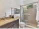Clean bathroom with granite countertop, dark brown vanity, and shower/tub combo at 11678 Aucilla Dr, Venice, FL 34293