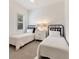 Charming bedroom with twin beds, window with plantation shutters, and neutral decor at 11678 Aucilla Dr, Venice, FL 34293