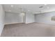 Bright bonus room featuring neutral walls, carpet, and ceiling fans at 11678 Aucilla Dr, Venice, FL 34293