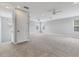 Spacious bonus room with carpet, ceiling fan, and multiple windows at 11678 Aucilla Dr, Venice, FL 34293
