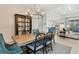 Open concept dining area with chandelier and built-in hutch at 11678 Aucilla Dr, Venice, FL 34293