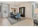 Elegant dining room with a rustic wooden table and blue chairs at 11678 Aucilla Dr, Venice, FL 34293