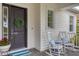 Front porch with rocking chairs and a welcoming wreath at 11678 Aucilla Dr, Venice, FL 34293