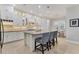 Modern white kitchen with an island and stainless steel appliances at 11678 Aucilla Dr, Venice, FL 34293