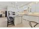 White kitchen with large island, glass cabinets and tiled backsplash at 11678 Aucilla Dr, Venice, FL 34293