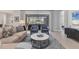 Living room featuring a beige sectional sofa and sliding glass doors at 11678 Aucilla Dr, Venice, FL 34293
