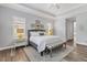 Main bedroom with high ceilings, large bed, and access to en-suite bathroom at 11678 Aucilla Dr, Venice, FL 34293