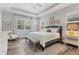 Spacious main bedroom with high ceilings, large bed, and relaxing decor at 11678 Aucilla Dr, Venice, FL 34293