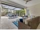 Covered patio with wicker furniture, pergola, and dining area at 11678 Aucilla Dr, Venice, FL 34293
