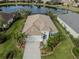 House with a lake view, showcasing the roof and landscaping at 12198 Wakulla Pl, Venice, FL 34293